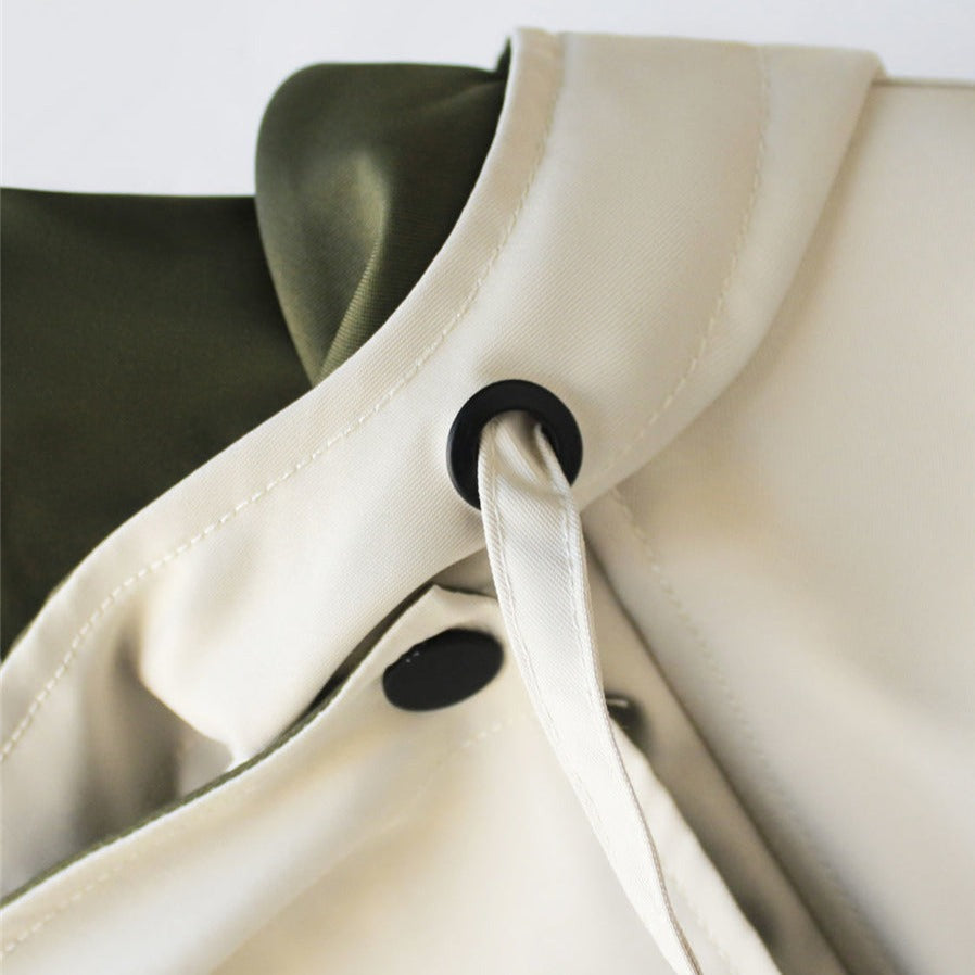 White windbreaker neckline with snap closure and black button detail.