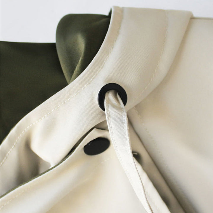 White windbreaker neckline with snap closure and black button detail.