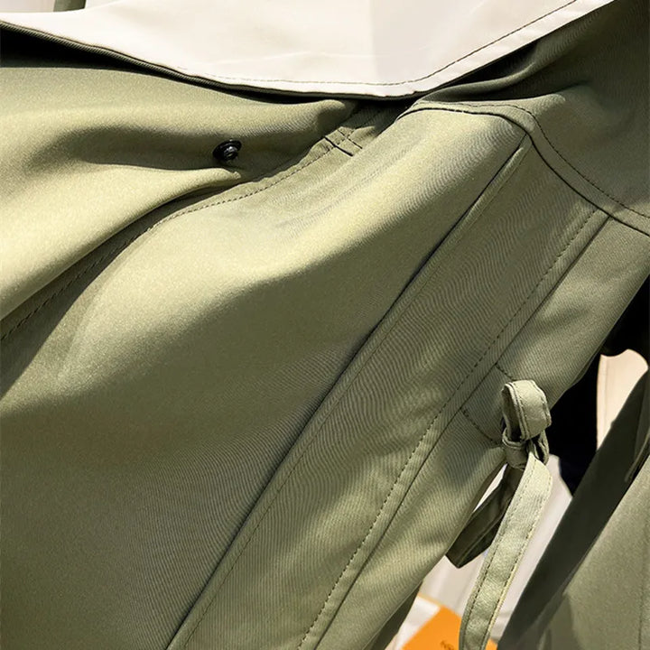 Green windbreaker jacket collar with snap buttons and partial front zipper