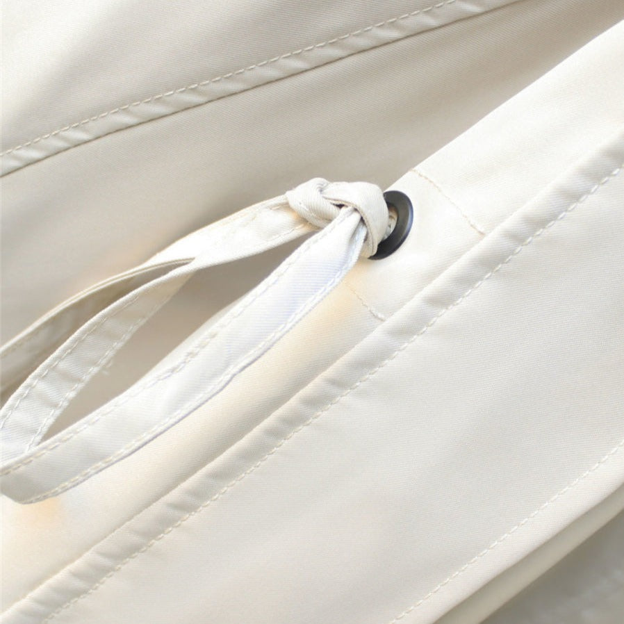 White windbreaker drawstring with metal eyelets and snap button detail.