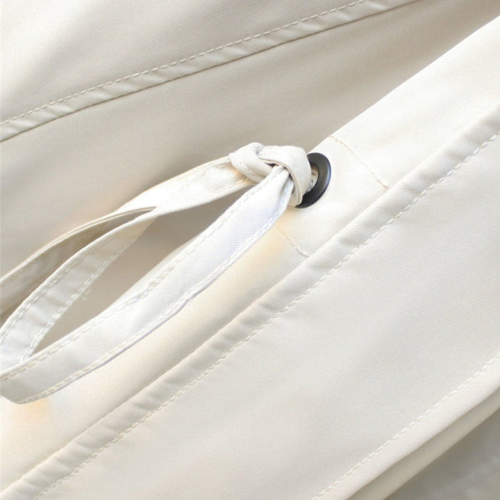 White windbreaker drawstring with metal eyelets and snap button detail.