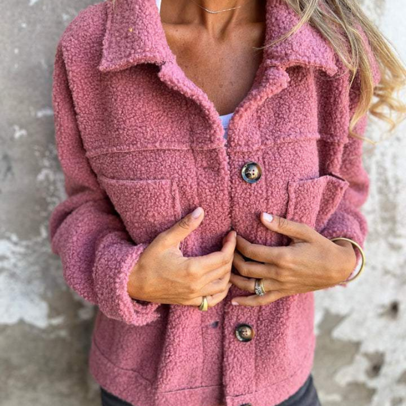 Pink teddy jacket close-up with button front and two flap chest pockets