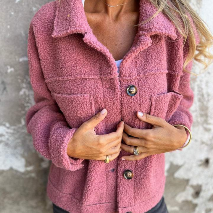 Pink teddy jacket close-up with button front and two flap chest pockets