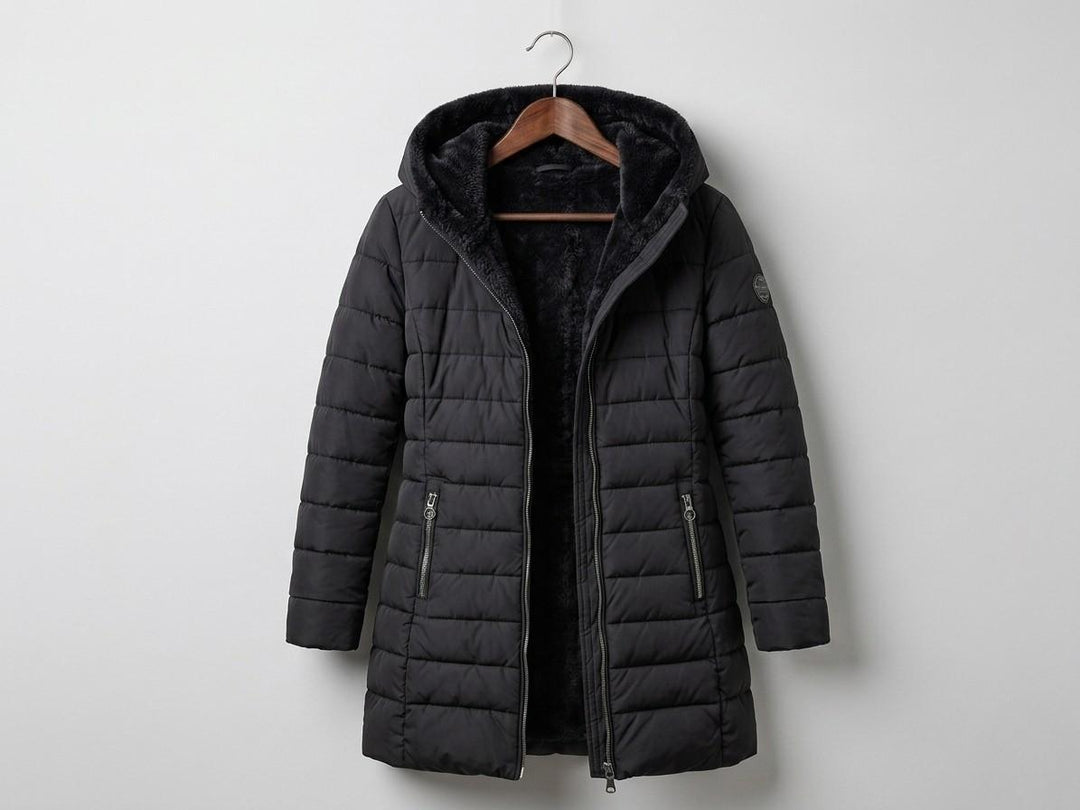 Black quilted A-line winter coat with hood, front zip, and side zip pockets.