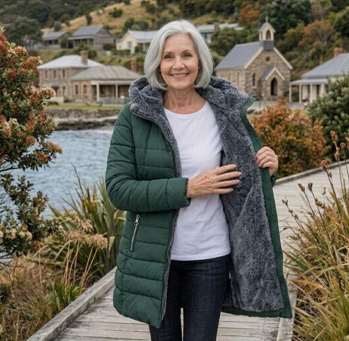 Dark green quilted A-line winter coat with gray fleece lining and zip front
