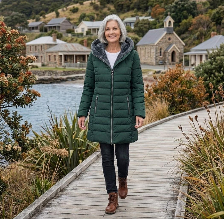 Dark green quilted A-line winter coat with hood, zip front, and side zip pockets.