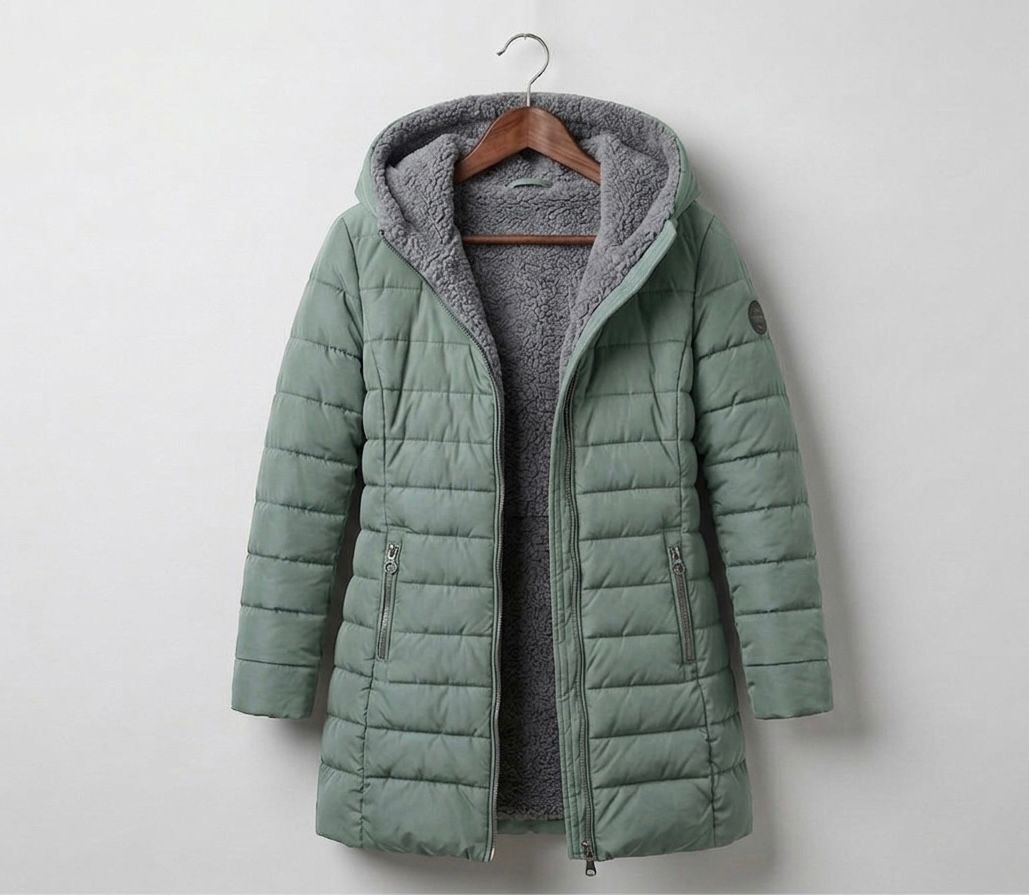Light green quilted A-line winter coat with hood, front zip, and side zip pockets.