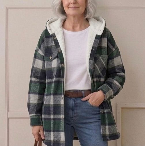 Hooded flannel shacket in green and dark plaid with cream sherpa hood lining and snaps