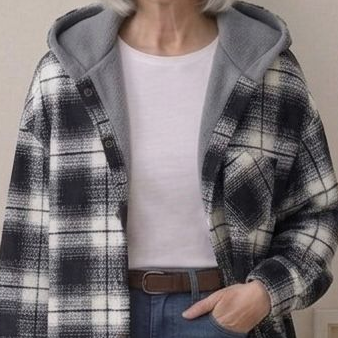Hooded flannel shacket close-up: black-and-white plaid with sherpa hood lining