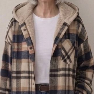 Hooded flannel shacket close-up: beige-and-navy plaid with tan sherpa hood lining