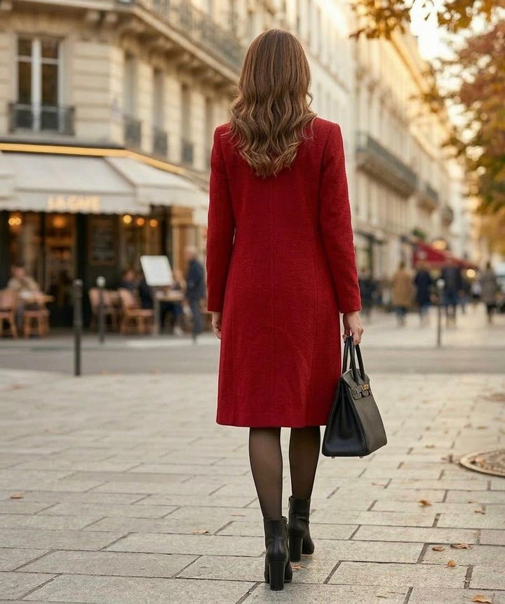 Red mid-length coat, back view with long sleeves and button closure.