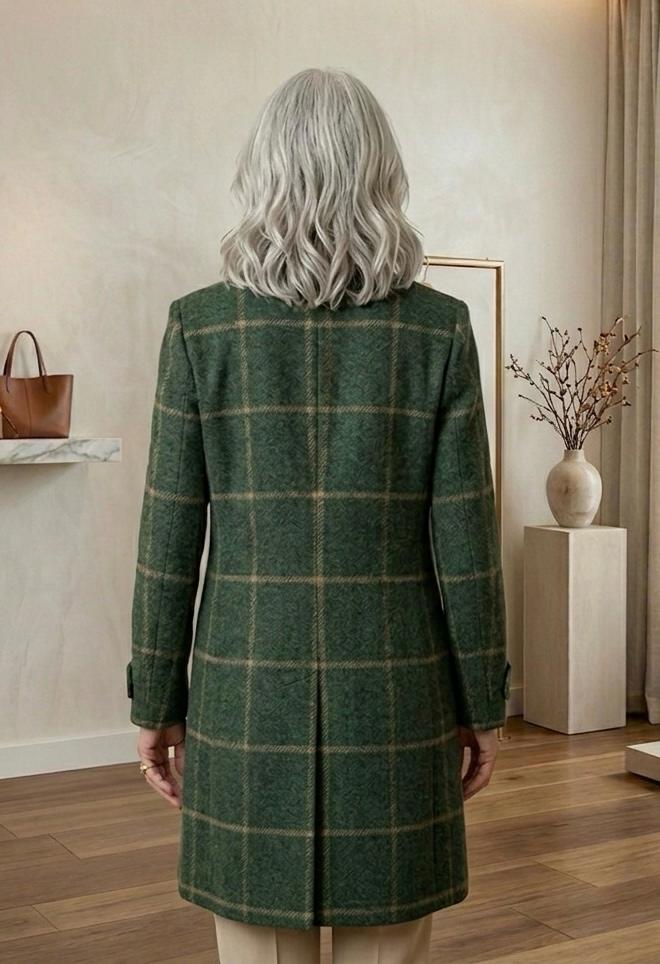 Back view of dark green plaid tweed coat with vented hem