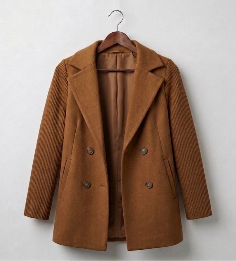 Brown ribbed blazer coat on hanger with four front buttons and pockets