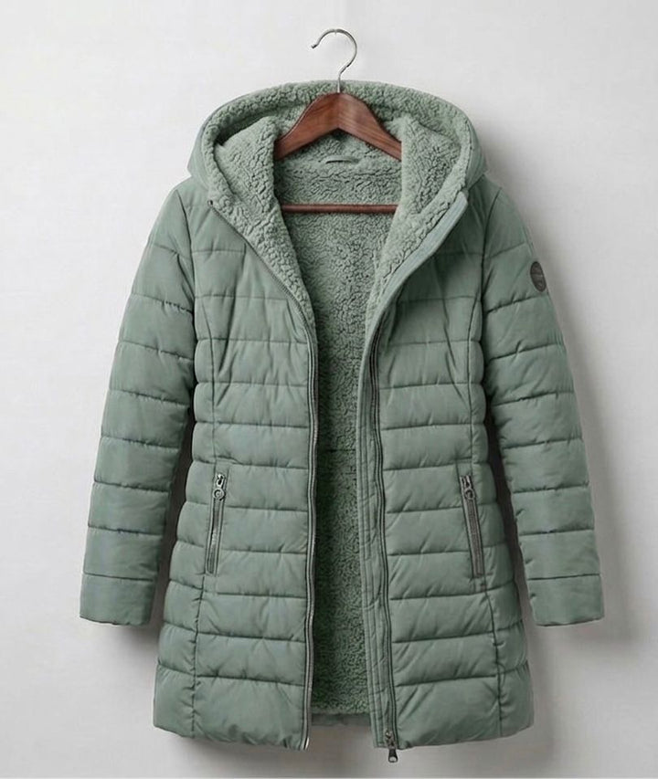 Light green quilted A-line winter coat with hood, front zipper, and side zipper pockets