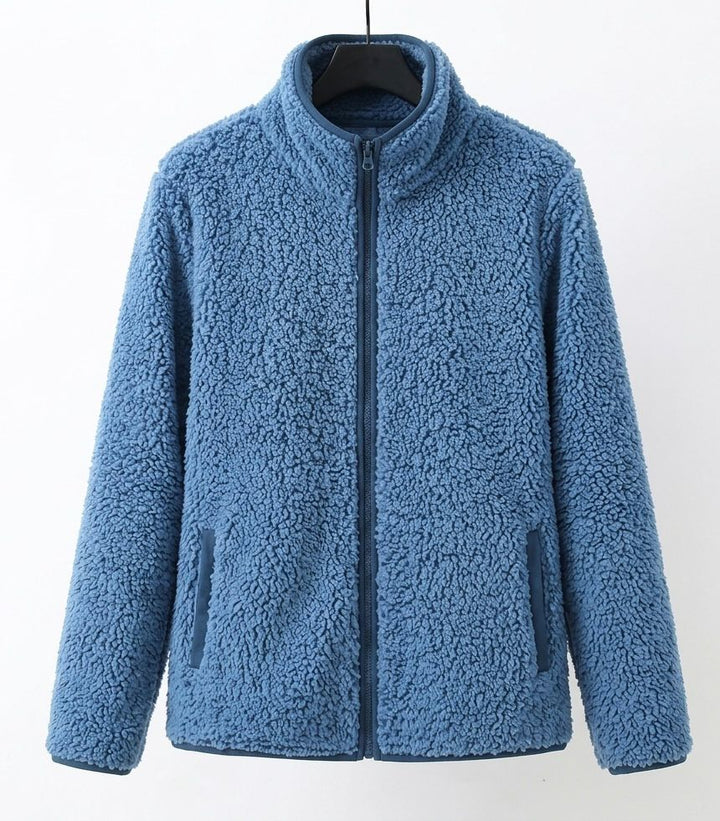Blue teddy jacket with full-zip front and side pockets, stand collar.