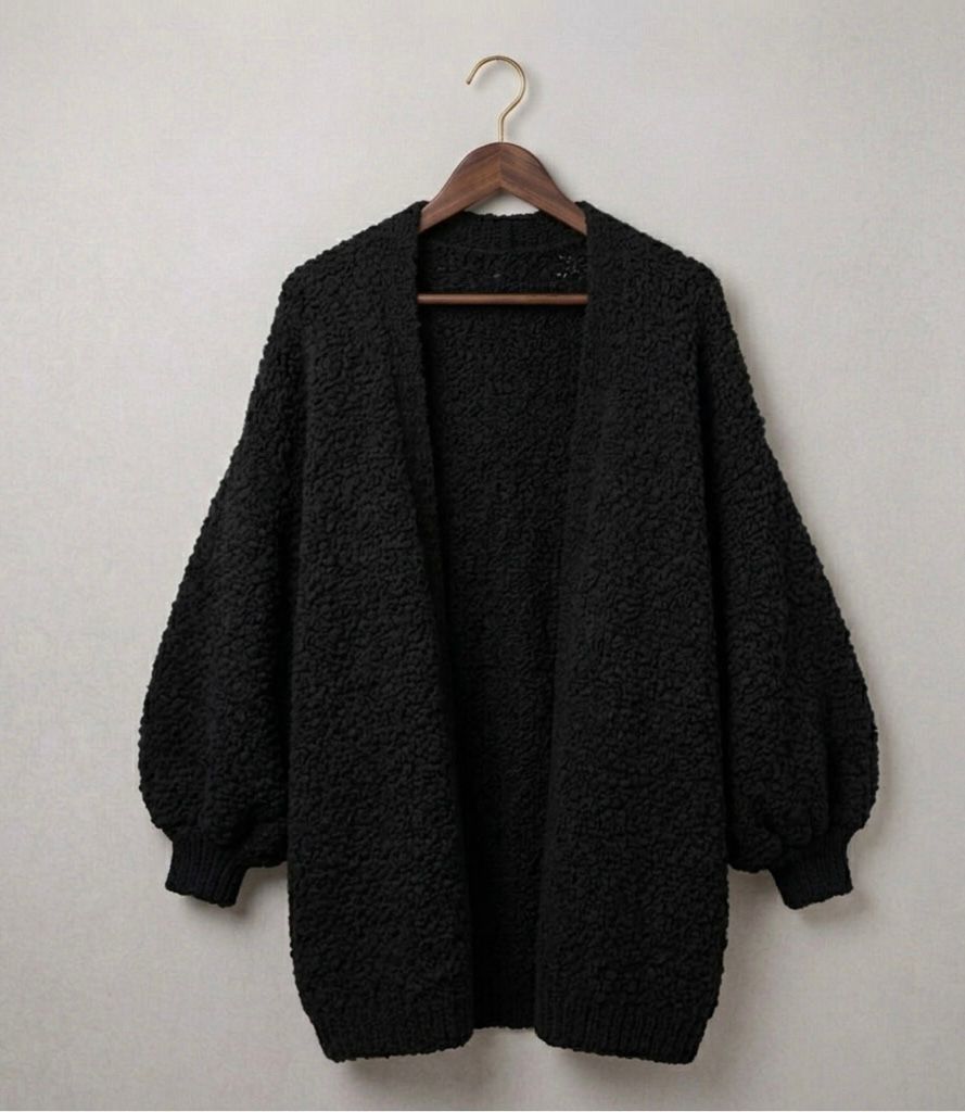Black relaxed knit cardigan with open front, textured knit, and ribbed hem and cuffs