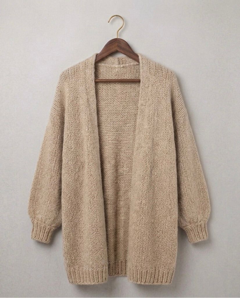 Beige relaxed knit cardigan with open front, chunky sleeves, and ribbed hem cuffs
