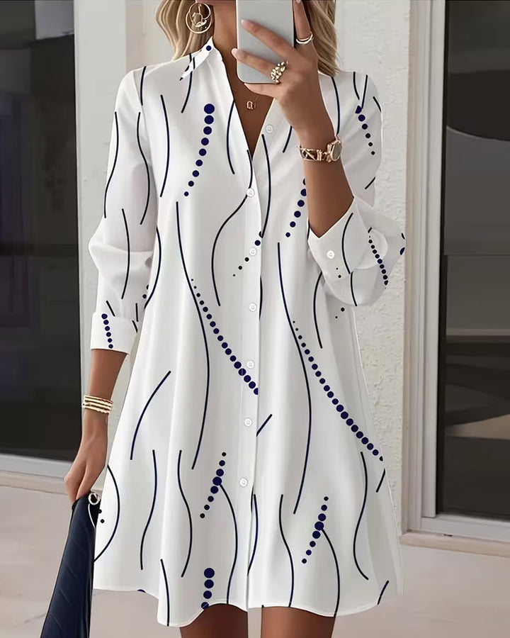 White long-sleeve shirt dress with navy abstract wavy print, button-front and collar