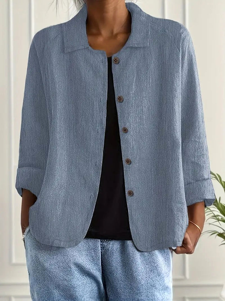 Light blue wrap blouse with button-front, notched collar, 3/4 sleeves