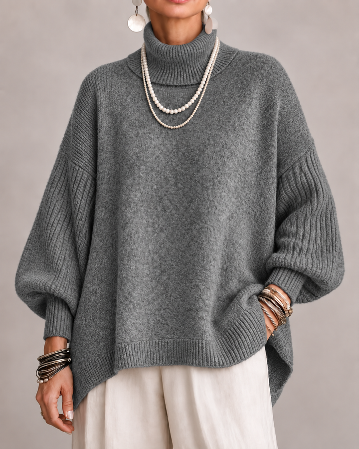 Dark gray turtleneck knit sweater with ribbed cuffs and relaxed dolman sleeves.