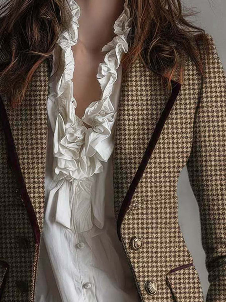 Brown houndstooth tweed blazer front view with dark piping, two buttons, and flap pocket