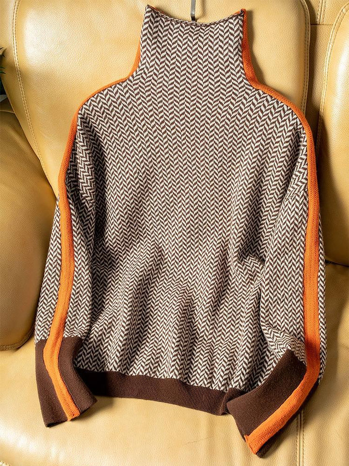 Women’s roll neck sweater with chevron knit and orange contrast trim at cuffs and edges