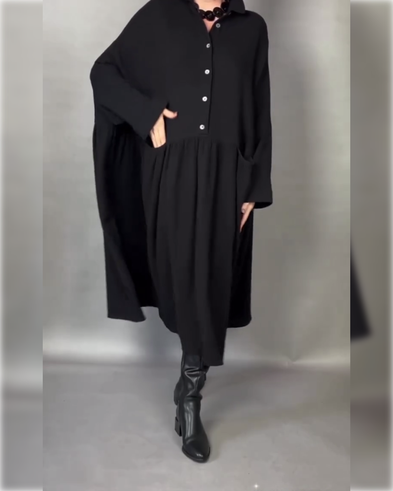 Black A-line button-front dress with point collar and long sleeves, flared hem.