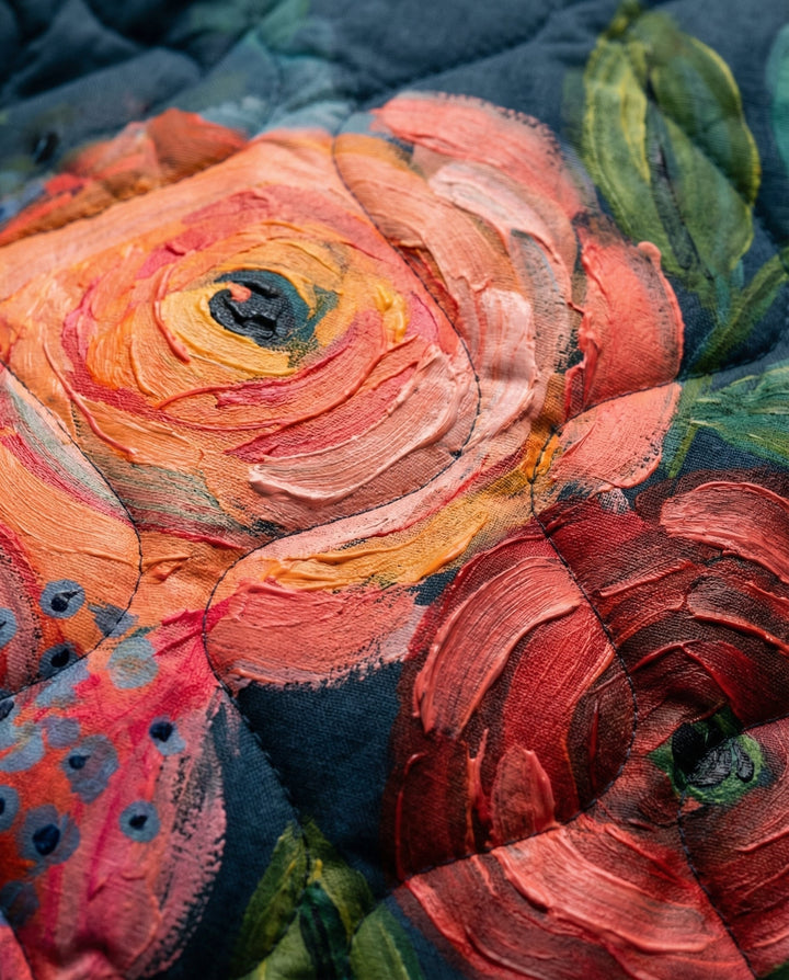 Floral quilted fabric detail with large rose blossoms in orange, pink, and green