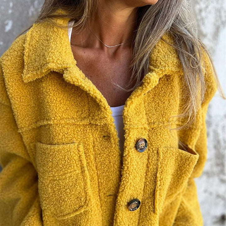 Yellow teddy jacket close-up with button front and flap chest pockets