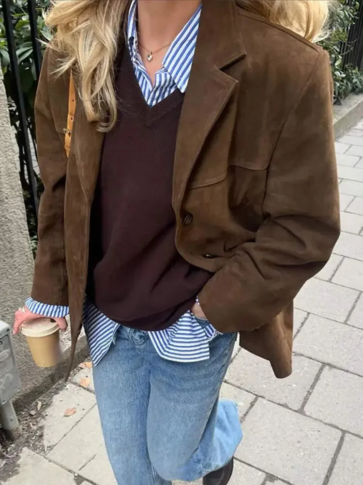 Brown textured blazer jacket close-up with notched lapels and button flap pocket