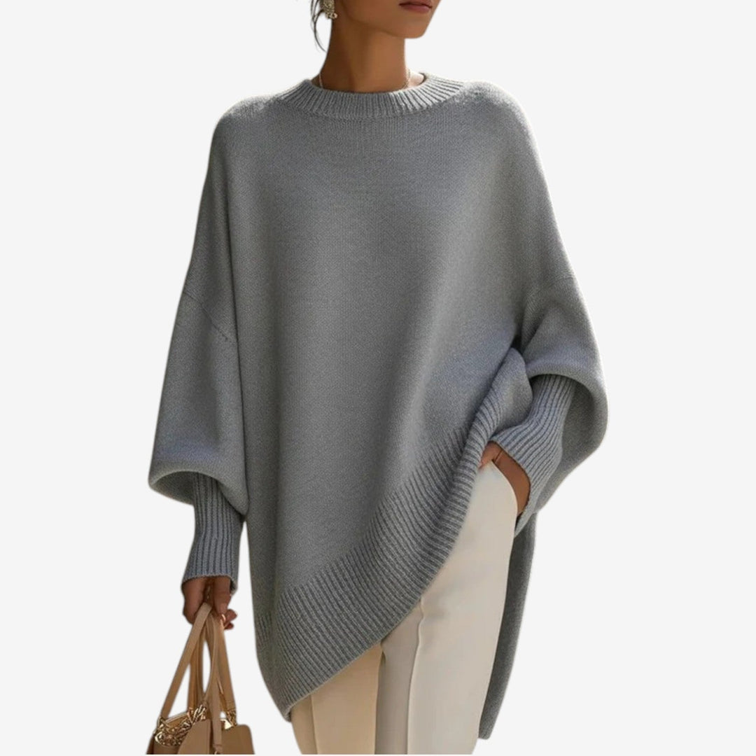 Grey asymmetric draped knit poncho with wide batwing sleeves and ribbed hem