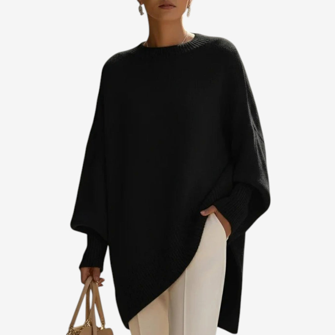 Asymmetric draped poncho sweater, black knit with ribbed hem and wide draped sleeves