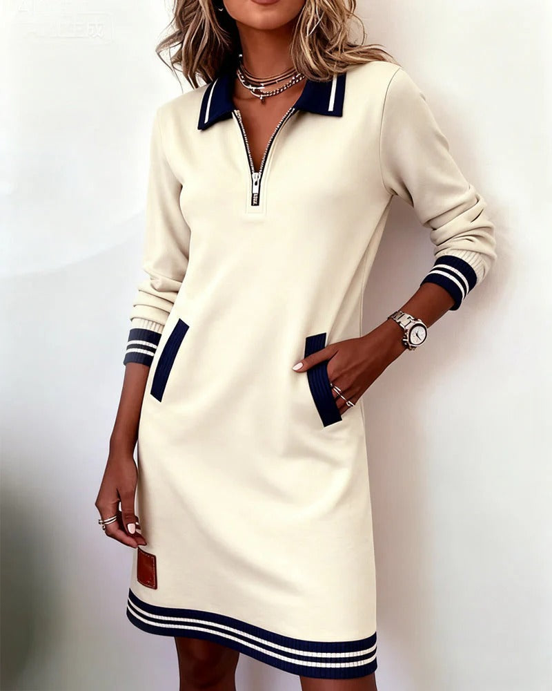Cream long-sleeve cotton shirt dress with quarter-zip, navy trim, and striped hem