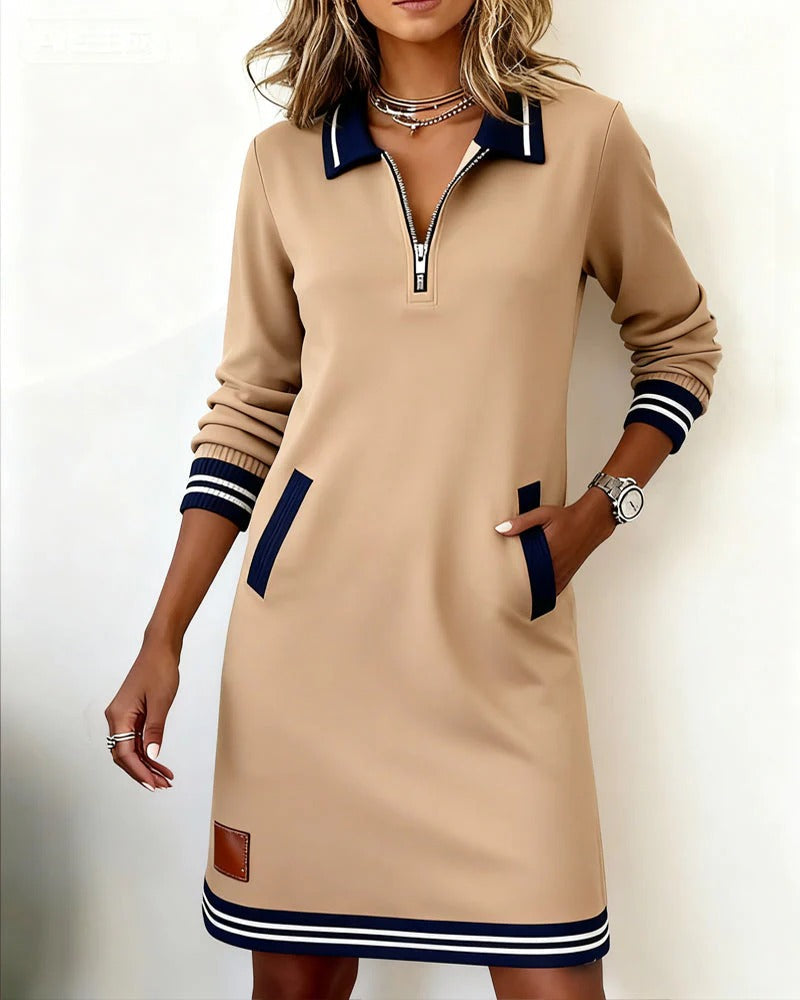 Beige long-sleeve cotton shirt dress with quarter-zip, navy trim, and contrast hem stripes
