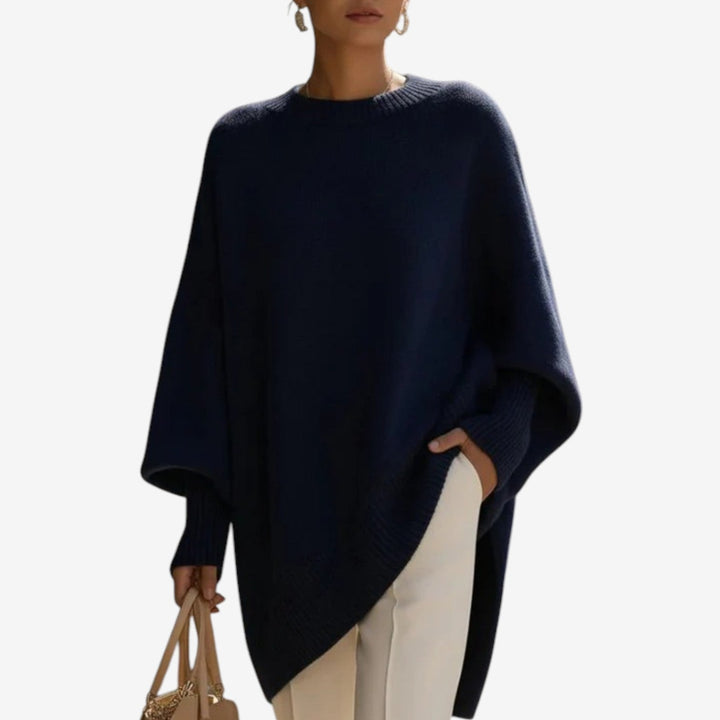 Asymmetric draped poncho sweater, dark blue knit with ribbed hem and draped sleeve