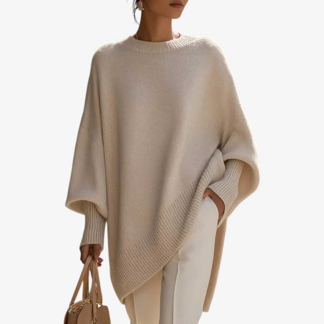 Cream asymmetric draped knit poncho with ribbed neckline and hem