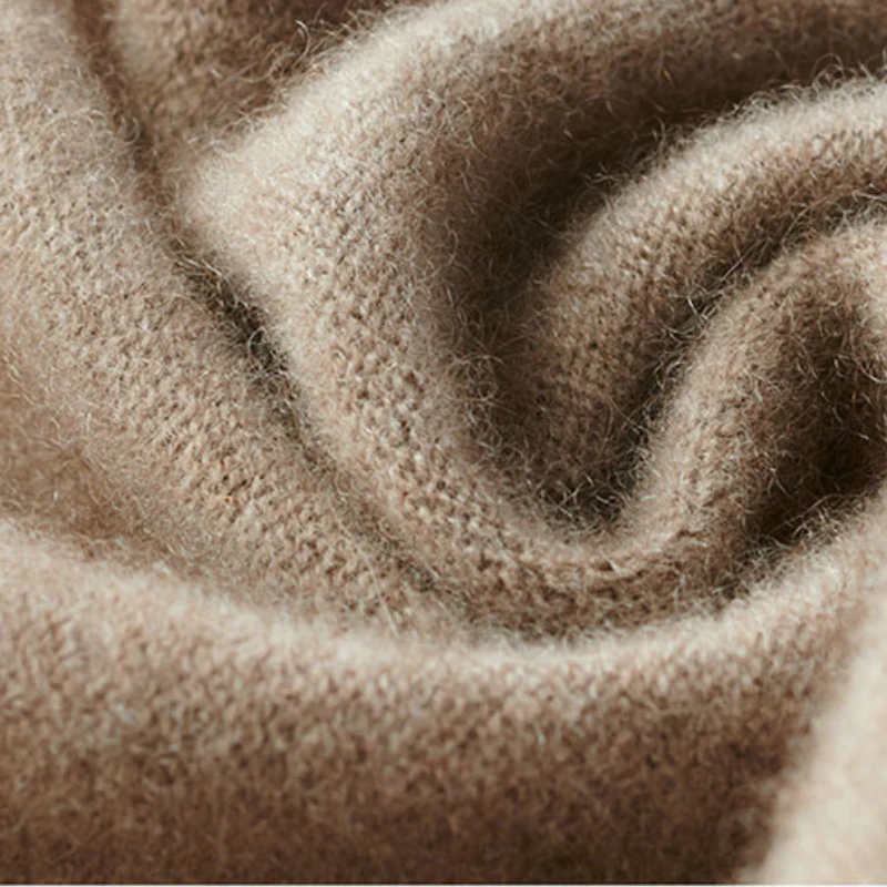 Close-up of taupe merino wool fabric with dense, textured knit surface