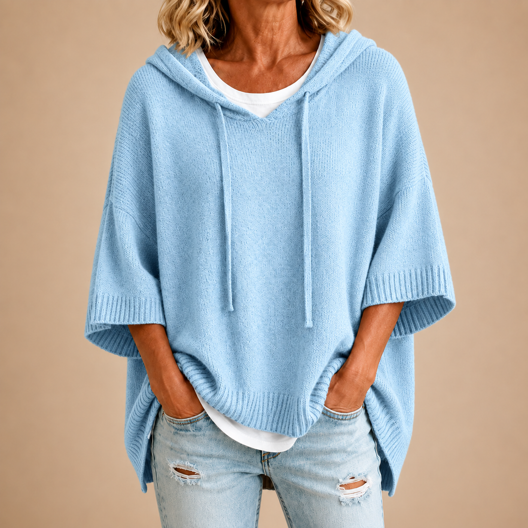 Light blue knit hooded poncho with loose fit and drawstring ties