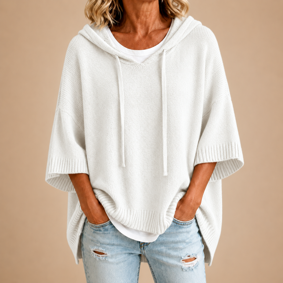White knit poncho with hood, loose drape and short sleeves