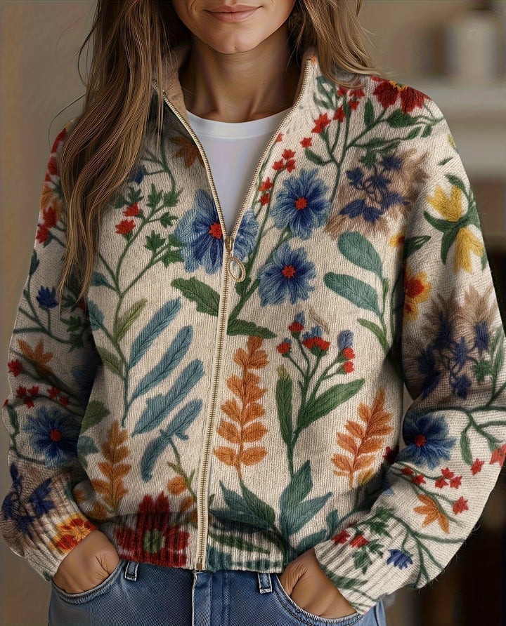 Floral zip cardigan in cream with blue, red, and green botanical print, front zipper
