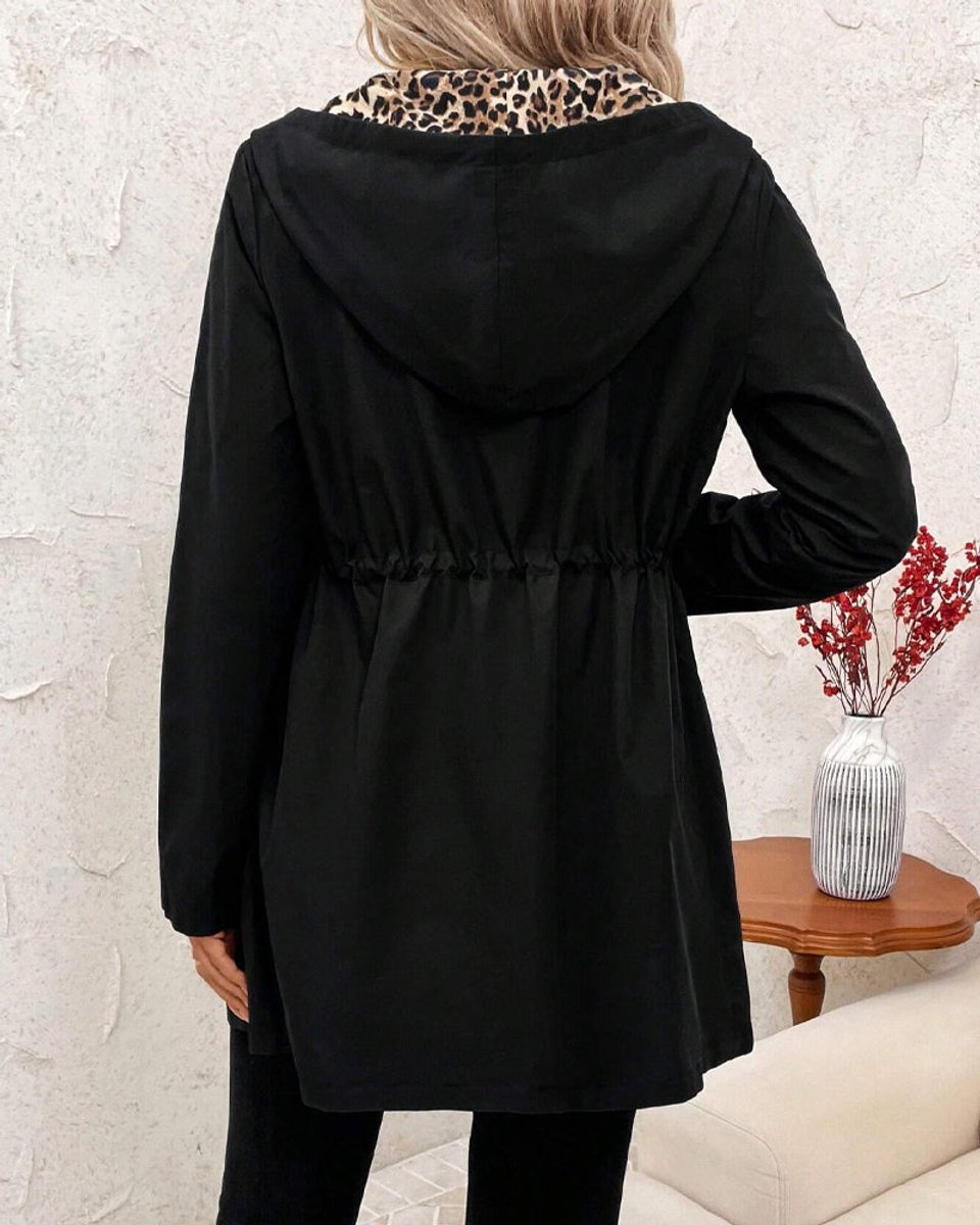 Reversible hooded zip jacket, back view in solid black with gathered waist.