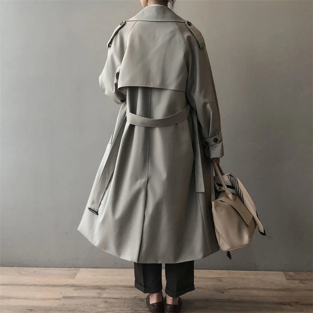 Long double-breasted trench coat, light gray, belted back, buttoned storm flap
