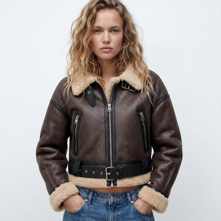Brown shearling-collared bomber jacket with front zip, black trim, and utility pockets