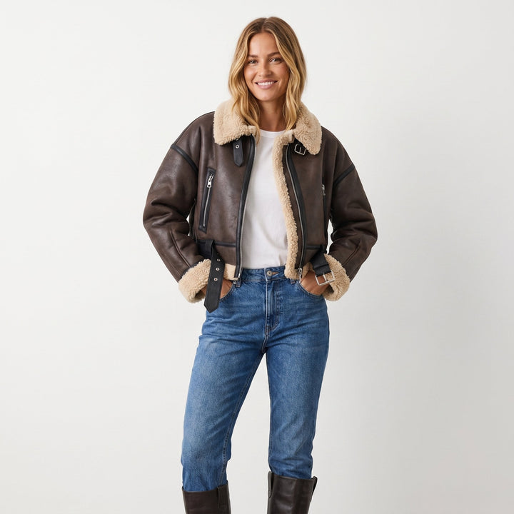 Brown shearling-collared bomber jacket with front zip, pockets, and fitted waist belt
