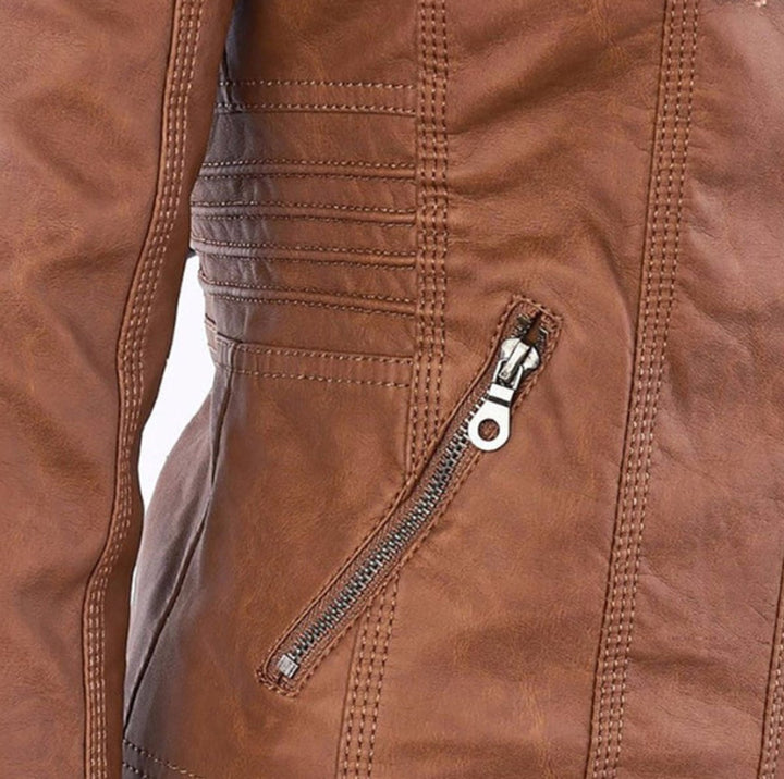 Brown biker jacket close-up: diagonal zip and pocket with metal zipper pull