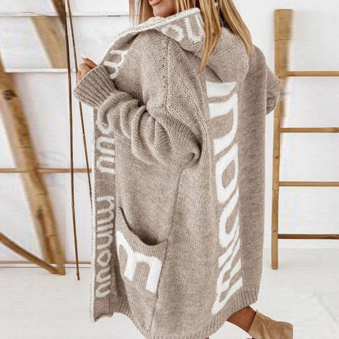 Light beige knitted hooded vest with white side lettering-style pattern