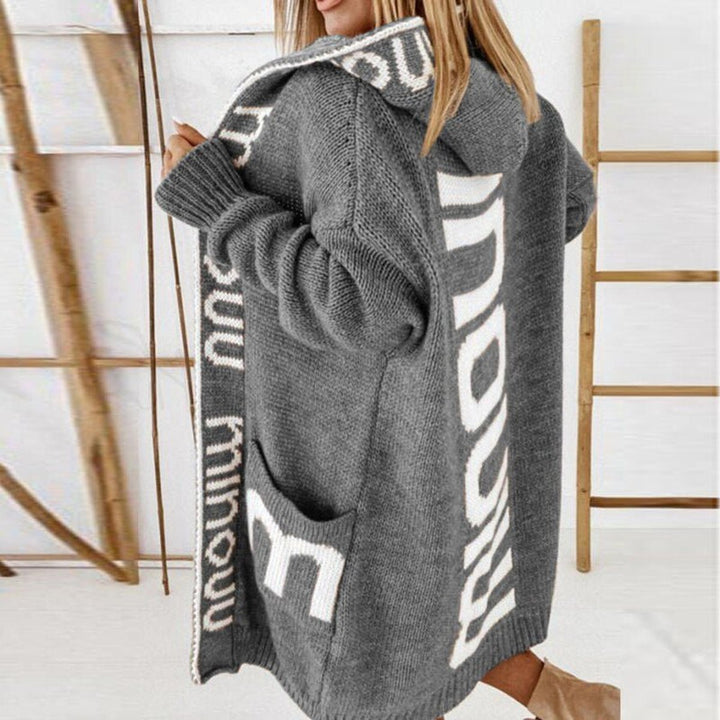 Gray knitted hooded vest with white graphic trim and front pouch