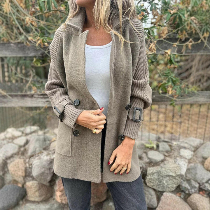 Taupe knit blazer-style jacket with notch lapels, double buttons, two pockets, buckled strap cuffs
