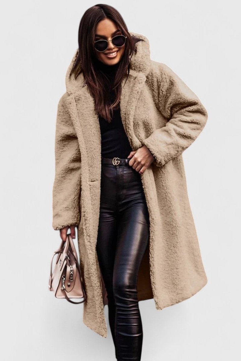 Beige long hooded winter coat with sherpa-like texture, open front and front pockets.