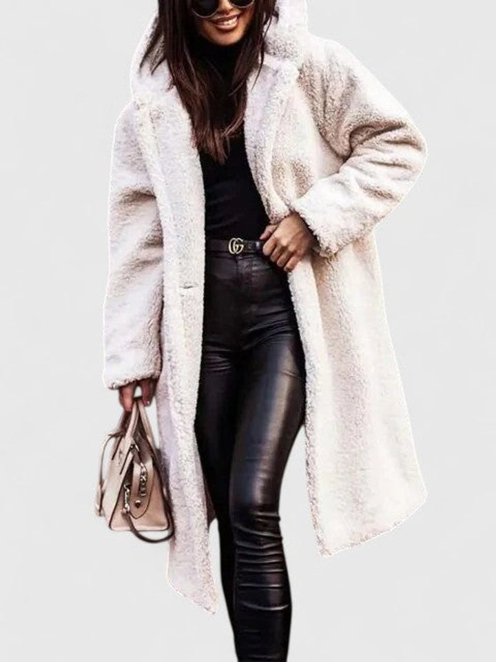 White long hooded winter coat with sherpa-like fuzzy texture, open front and pockets.